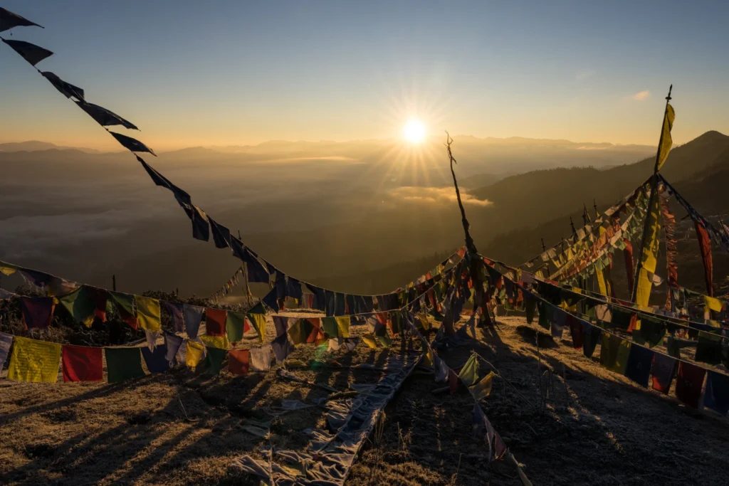 Prayer flags silhouetted against the sunset in Bhutan