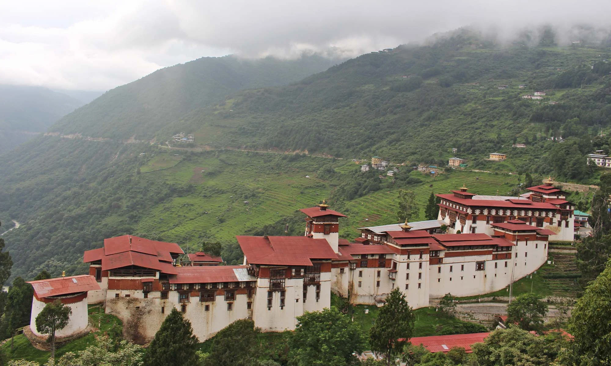 Village houses among green fields in Trongsa