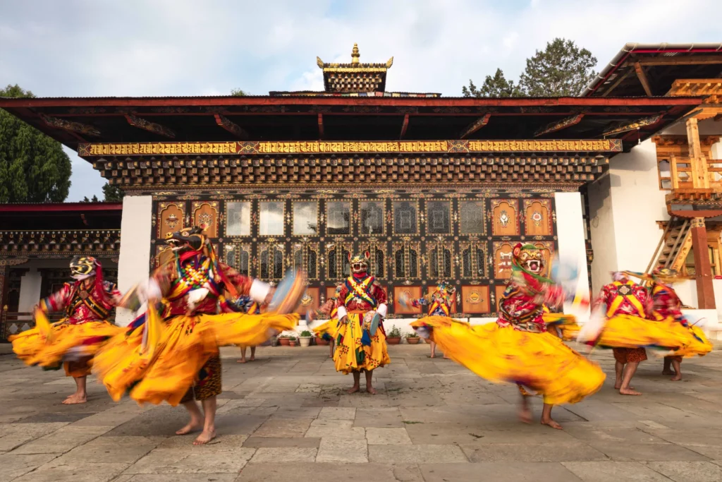 Masked dance in a dzong courtyard during a tshechu